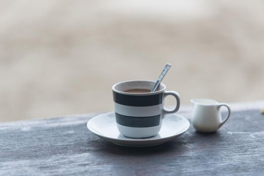 Coffee cup on wooden table outdoor background