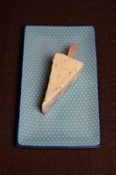 top view of a delicious triangular dessert ice cream. dessert with a delicate filling on a blue plate.