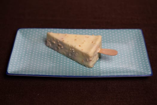 delicious triangular dessert with delicate filling on a blue plate.