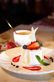 a beautiful fresh white dessert in a restaurant on the table. original dessert serving.