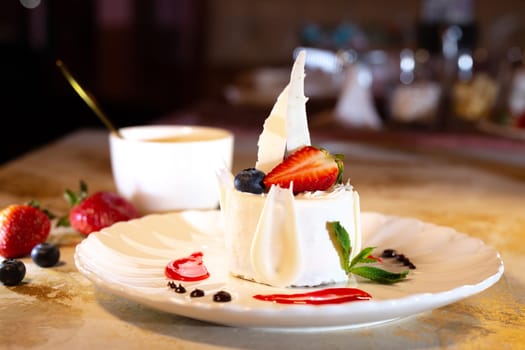 a beautiful fresh white dessert in a restaurant on the table. original dessert serving.