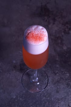 top view of an orange summer cold cocktail on a gray background.