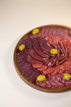meat sliced from delicacies on a wooden stand top view.