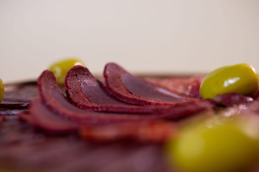 close-up of meat sliced from delicacies on a wooden stand