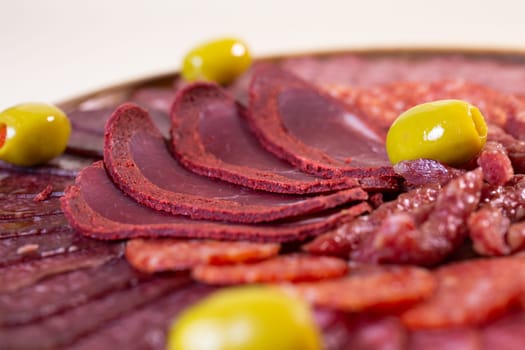 close-up of meat sliced from delicacies on a wooden stand