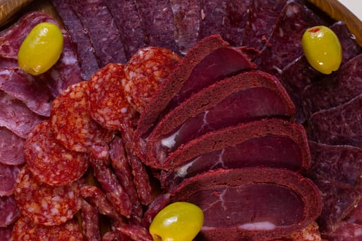 close-up of meat sliced from delicacies on a wooden stand