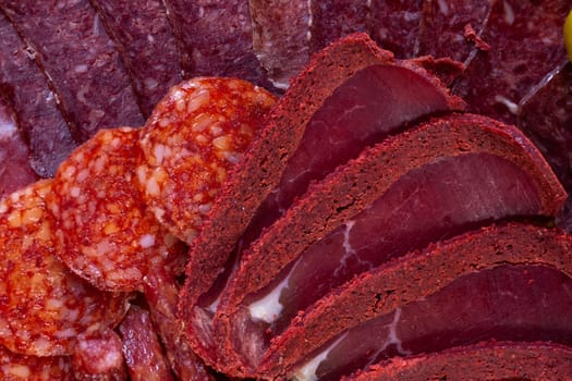 close-up of meat sliced from delicacies on a wooden stand