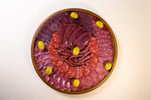 meat sliced from delicacies on a wooden stand top view.