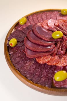 meat sliced from delicacies on a wooden stand top view.