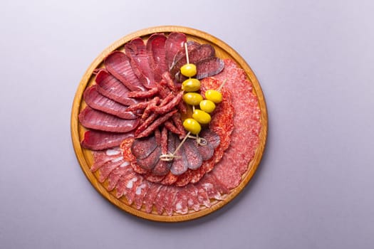 meat sliced from delicacies on a wooden stand top view.