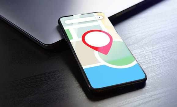 Local SEO - Optimize Online Presence for Nearby Customers and Boost Offline Business with Effective Strategies. Smartphone on the screen of which a map with red pin mark.