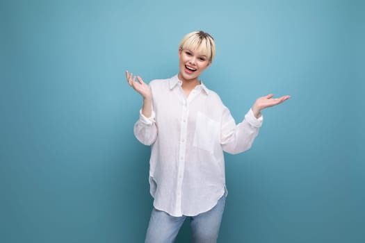 young charming pleasant pretty caucasian office worker woman with short blond hair is dressed in a white blouse on a background with copy space. business concept.