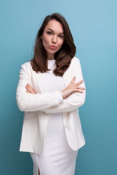 vertical portrait of a brunette woman in an elegant dress with a grimace and emotions on her face.