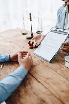 Young African American lawyer studying a case for a client and signing a legal contract to fight her opponent in court. Legal and lawyer concepts