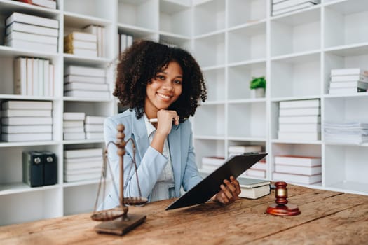 A young women African American lawyer lawsuit studying cases for clients in a law firm to fight against their parties in the courts. law and attorney concepts