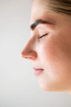 Close-up portrait of a woman after the procedure of correction and lamination of eyebrows