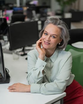 Mature caucasian woman at the desk in the office