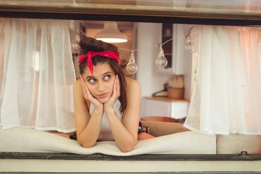 Happy hippie girl are having a good time in a camper trailer. Holiday, vacation, trip concept.High quality photo