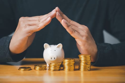 A piggy bank with coins stacked beside it, symbolizing the concept of saving and investing money. The idea of financial planning and wealth management is important for economic stability.