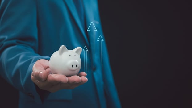 Save money and investment growth concept, Businessman hand holding piggy bank, Financial and business, Management money.