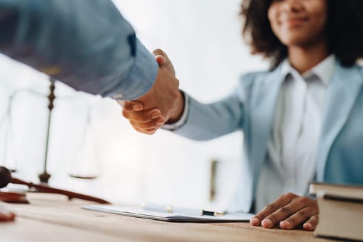 Law, consultation, agreement, contract, lawyer or attorney shakes hands to agree on the client's offer to be hired to fight the parties in court