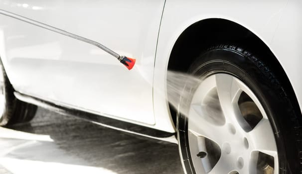 Washing a car in a self-service car wash station with wahing foam. Wash car self-service station.