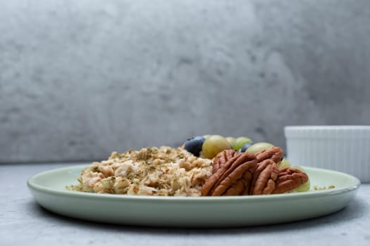 Oatmeal Porridge With Hemp Protein Powder, Berries, Nuts On Plate. Copy Space Above. Healthy Breakfast With Plant-derived Protein from Cannabis Plant. Superfood, Healthy Meal. Horizontal Plane.