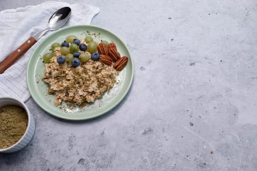 Top View Oatmeal Porridge With Hemp Protein Powder, Nuts, Berries, Bowl With Plant-derived Protein From Cannabis Plant, Spoon. Copy Space. Healthy Breakfast, Meal. Superfood. Horizontal Plane.