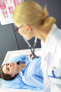 Doctor and patient discussing something while sitting at the table . Medicine and health care concept.