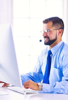 Businessman in the office on the phone with headset, Skype, FaceTime.