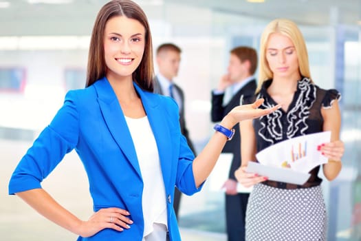 Happy businesswoman holding a paper.