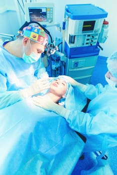 Man surgeon at work in operating room.