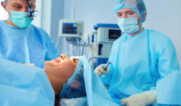 Man surgeon at work in operating room.