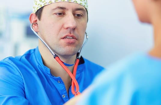 Man surgeon at work in operating room.