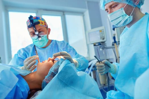 Man surgeon at work in operating room.