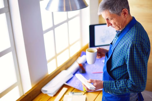 Architect working on drawing table in office.