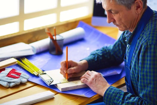 Architect working on drawing table in office.