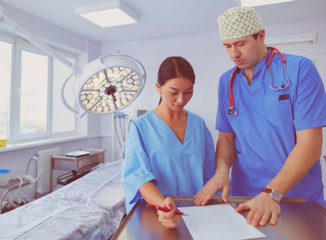 Man surgeon at work in operating room.