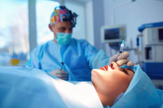 Man surgeon at work in operating room.