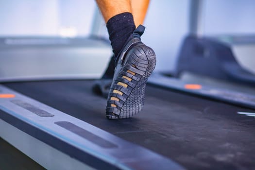 Group of people at the gym exercising on cross trainers. People at the gym