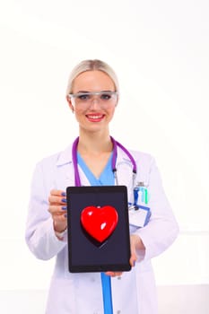 Young woman doctor holding a red heart, isolated on white background. Woman doctor.