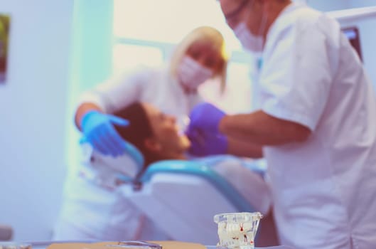 Dentist man with patient woman in clinic.