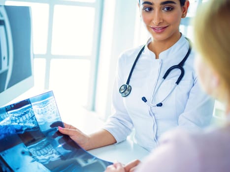 Female doctor giving a consultation to a patient and explaining medical informations and diagnosis.