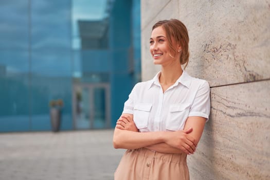 Businesswoman successful woman business person standing arms crossed outdoor corporate building exterior Smile happy caucasian confidence professional business woman middle age female entrepreneur