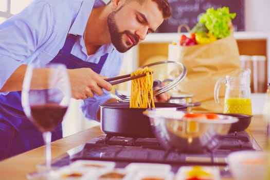 Man preparing delicious and healthy food in the home kitchen.