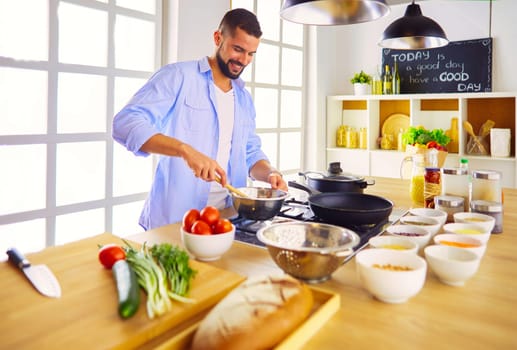 Man preparing delicious and healthy food in the home kitchen.