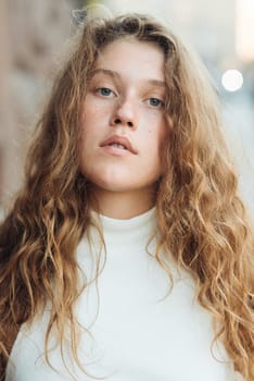 close up portrait of a fashionable young girl with curly hair. High quality photo