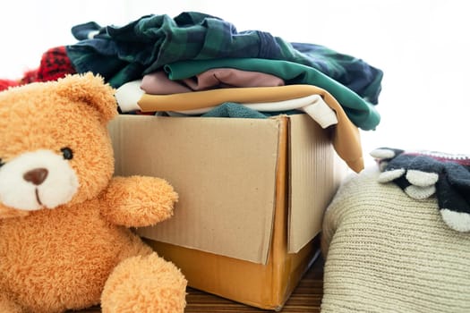 Donation box with used clothes at home to support help for poor people in the world.