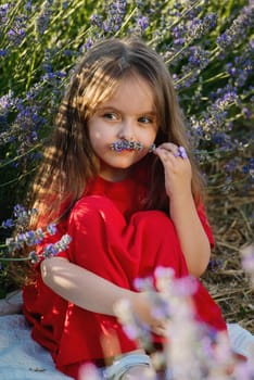Portrait of cute little girl in the lavender flowers in meadow.