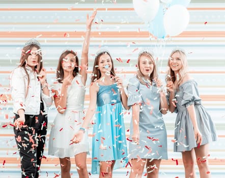 Happy girls at birthday party with balloons and confetti